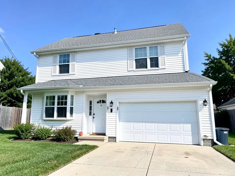 AI-drawn generic stand-in of a two-story white house with white vinyl siding, white window frames and louvered shutters, a white garage door, a white front door and a gray shingle roof
