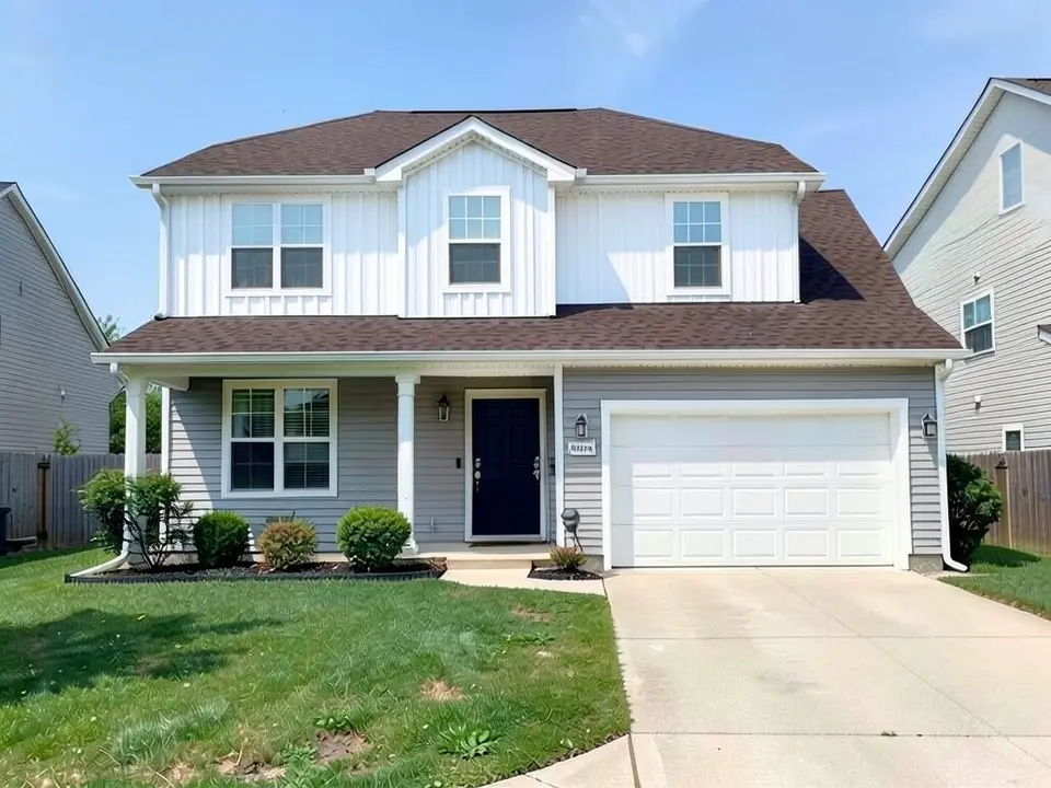 The same house with white vertical board and batten siding on the upper floor and the front gable, and the light gray horizontal siding kept on the ground floor and the garage wall