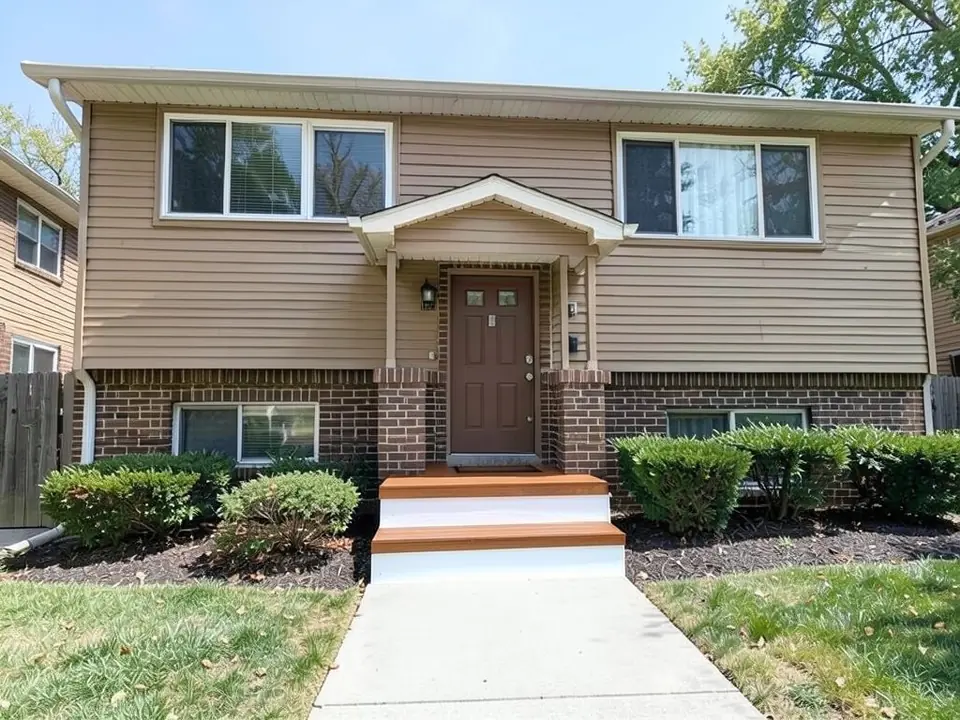 The same house with warm brown wood-look treads and white-painted risers on the entry steps; door, brick, siding, shrubs and concrete walkway unchanged