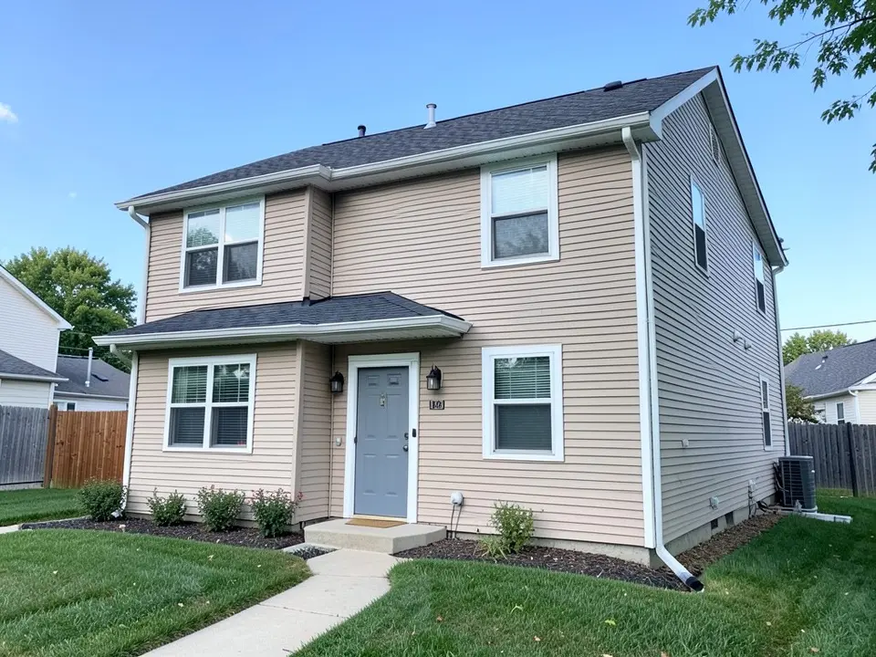 AI-drawn generic stand-in of a beige horizontal vinyl-sided two-story house with white window trim and white corner trim, a gray front door and a dark gray roof