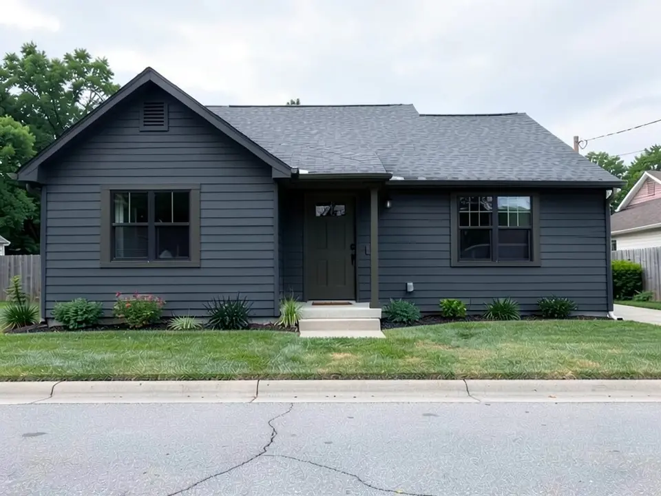 The same ranch house with charcoal siding and charcoal trim; the black windows and gray roof kept