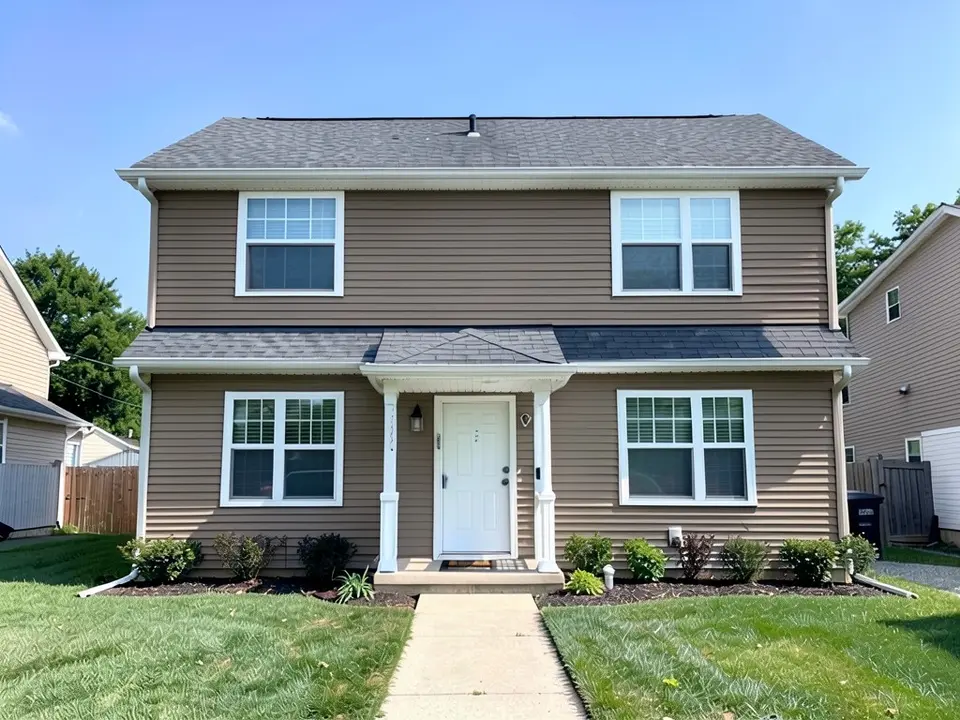 The same house with medium brown siding; white trim, white door and gray roof kept