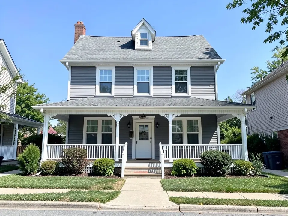AI-drawn generic stand-in of a two-story house with gray wood siding, white trim, a full front porch with white posts and railings and a gray shingle roof with a dormer