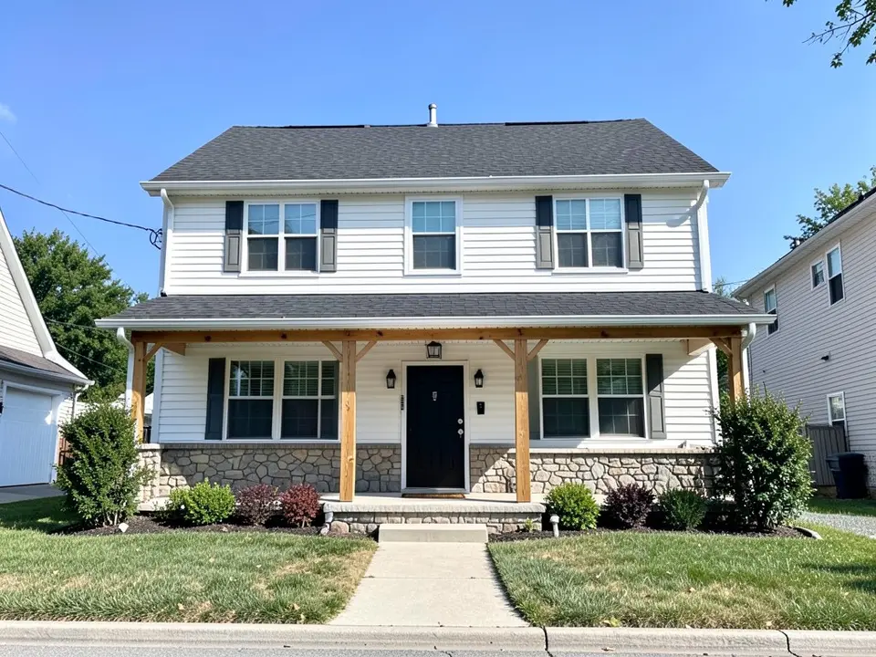 AI-drawn generic stand-in of a two-story house with white siding, black shutters, a stone base, natural wood porch posts, a black front door and a dark shingle roof