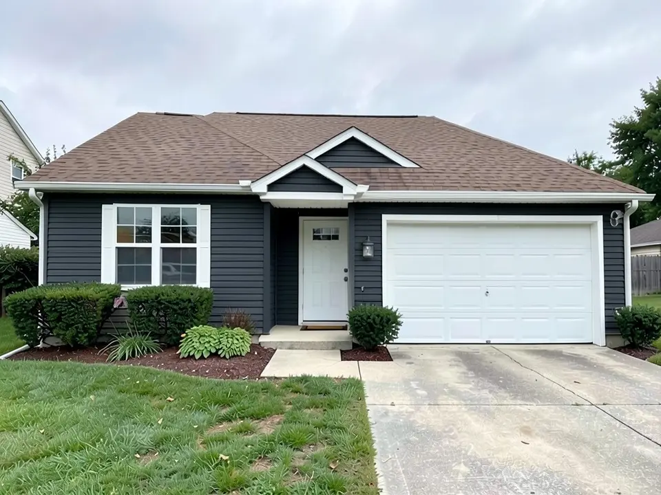 The same house with dark charcoal gray siding on the walls, gable and garage; white trim, white doors and brown roof kept