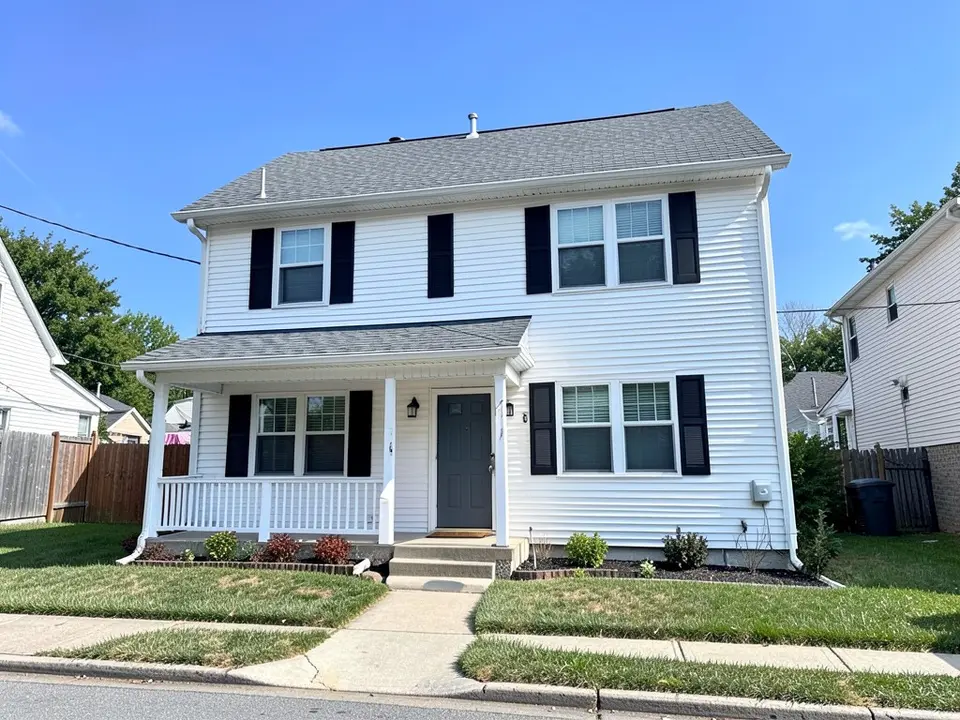 AI-drawn generic stand-in of a two-story house with white horizontal lap siding down to the ground, black shutters, a dark gray front door, a small porch with white railing and a gray shingle roof