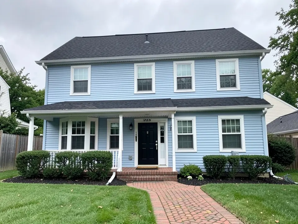 AI-drawn generic stand-in of a two-story colonial house with light blue vinyl lap siding, white trim, a black front door and a brick walkway